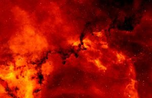 Astrônomos detectam um buraco negro supermassivo extremamente vermelho no universo primitivo crescendo nas sombras